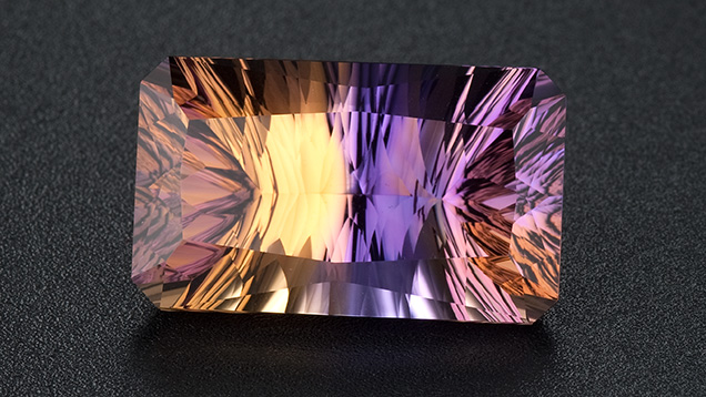A Spectacular Bicolor Gem. Ametrine is a form of quartz in which the colors of the amethyst and citrine quartz varieties are present in the same crystal. Photo by Robert Weldon/GIA, courtesy Minerales y Metales del Oriente, Bolivia, SA.