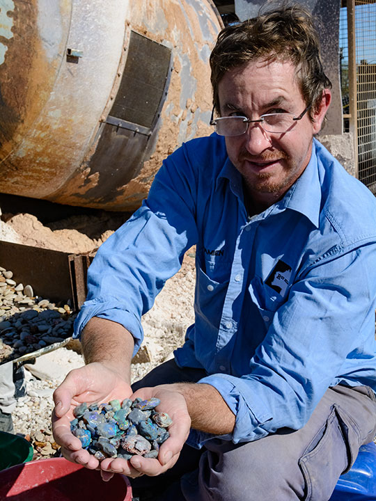DSC_2114_185755-540x720.jpg. Frederic Mallock’s partner, Damien Leis, proudly displays some of the mine’s black opal production after processing the ore from their mine at Lightning Ridge. Photo by Andrew Lucas/GIA.