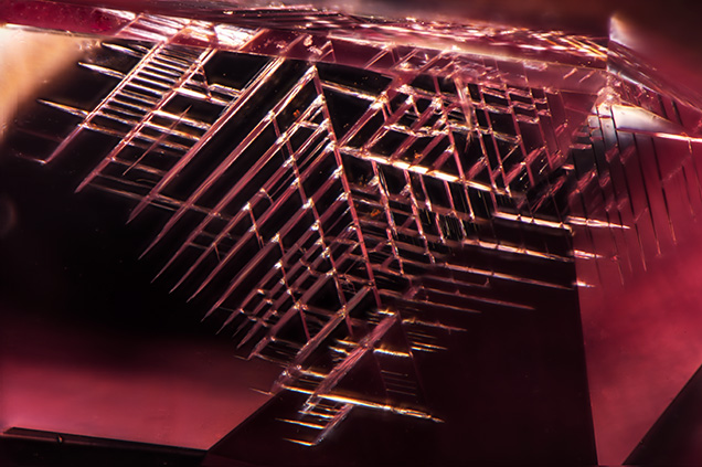 Cleavage along octahedral planes of pink diamond. Cleavage along octahedral planes of pink diamond.