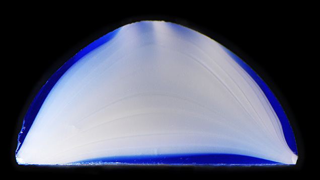 Cross section of the glass cabochon reveals flow lines. Cross section of the glass cabochon reveals flow lines.