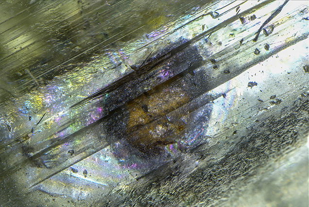 Unidentified orange inclusion in spodumene.