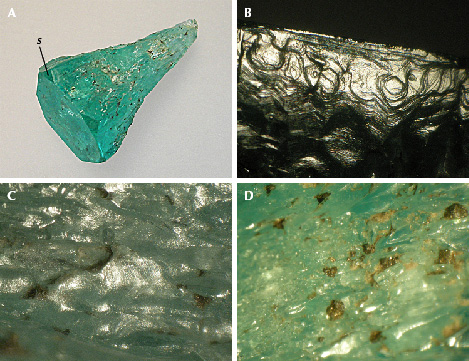 Figure 10. A: Sample 9 (20.8 mm in length), an emerald crystal with conical shape, with basal pinacoid c, small m prism faces, and hexagonal s dipyramids. B: Growth steps on the surface of one of the m prism faces, viewed almost perpendicular to the c-axis. C: Hillocks with fine micro-steps between irregularly shaped groves on the surface of the conical part. D: Residual dark gray carbonaceous material captured in indentations on the surface of the conical part. Photos by K. Schmetzer; fields of view 4.5 mm (B), 3.5 mm (C), and 7.6 mm (D).