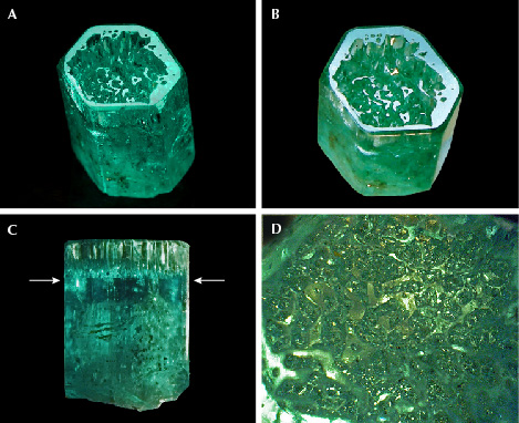 Figure 16. A: Sample 16 (10.8 mm in length), an emerald crystal developed in the form of a cup. B: The basal plane of the cup reflects together with the basal faces of small hillocks or columns in the cup. C: The bottom of the cup is located in the upper half of the crystal, as indicated by arrows. D: Framework of irregular hillocks, columns, and walls on the bottom of the cup in a view parallel to the c-axis. Photos by G. Martayan (A) and K. Schmetzer (B–D); field of view 4.6 mm (D).