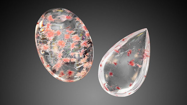 Figure 2. Weighing 11.18 ct (left) and 5.47 ct (right), these two rock crystal quartz cabochons play host to very unusual pink crystal sprays. Photo by Adriana Robinson. Figure 2. Weighing 11.18 ct (left) and 5.47 ct (right), these two rock crystal quartz cabochons play host to very unusual pink crystal sprays. Photo by Adriana Robinson.