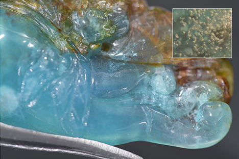 Transparent bubbles within the blue chalcedony carving. Transparent bubbles within the blue chalcedony carving.