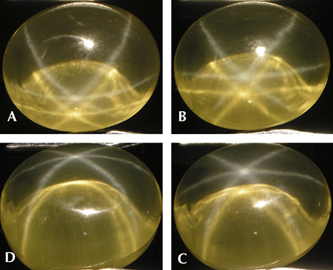 Yellow synthetic sapphire with a white star and a yellow star, shown with rotation of the cabochon Yellow synthetic sapphire with a white star and a yellow star, shown with rotation of the cabochon
