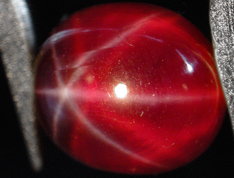 Synthetic ruby with white star and orange-red star Synthetic ruby with white star and orange-red star