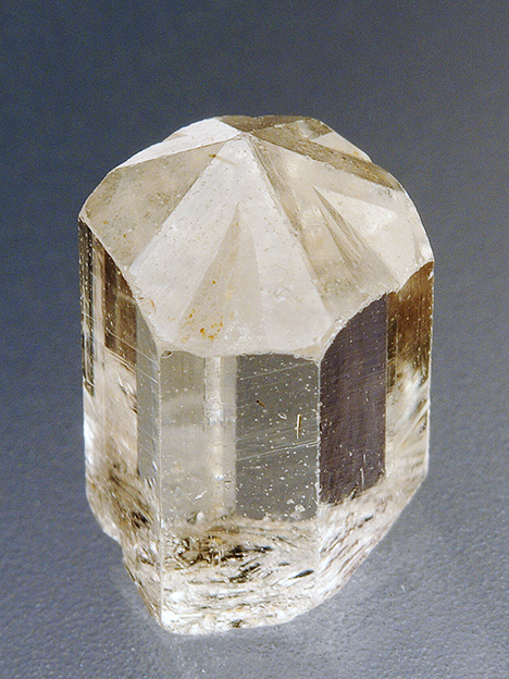 Phenakite twin with “drill bit” termination and perettiite-(Y) inclusions.