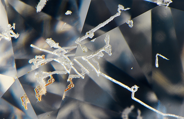 Natural etch channels and evidence of brown radiation stains in diamond. Natural etch channels and evidence of brown radiation stains in diamond.