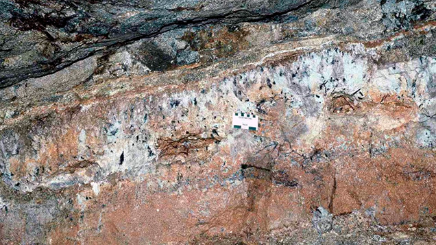 Figure 10. Underground exposure of a subhorizontal pegmatite dike at the San Diego mine near Mesa Grande in San Diego County, California, in 1986. Several open pockets, from which the contents have been removed, extend along the central portion of the dike, which is about 2 meters across from top to bottom. Courtesy of David London.