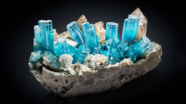 Figure 14. The “King of Kashmir” aquamarine crystal group, measuring 45 cm tall and 80 cm wide, was collected in 2019 from a miarolitic pegmatite dike in the remote Nyet Bruk region of the Skardu District in northern Pakistan (Trinchillo, 2020). It is considered by many to be one of the most significant gem mineral specimens found in the modern era. Photo by James Elliott/Fine Minerals International; courtesy of Daniel Trinchillo.