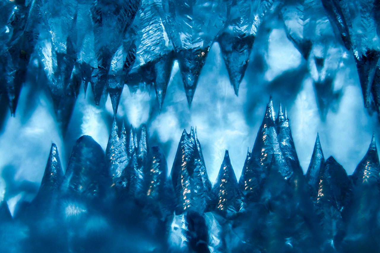 This aquamarine has been significantly etched, resulting in a cave-like cavity filled with sharp spires of beryl. Field of view 3.28 mm. This aquamarine has been significantly etched, resulting in a cave-like cavity filled with sharp spires of beryl. Field of view 3.28 mm.