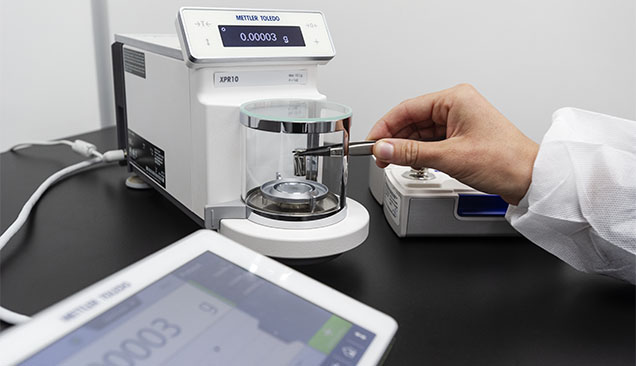 Figure 5. A GIA metrologist uses a calibrated standard to verify instrument performance. Photo by Kevin Schumacher. Figure 5. A GIA metrologist uses a calibrated standard to verify instrument performance. Photo by Kevin Schumacher.