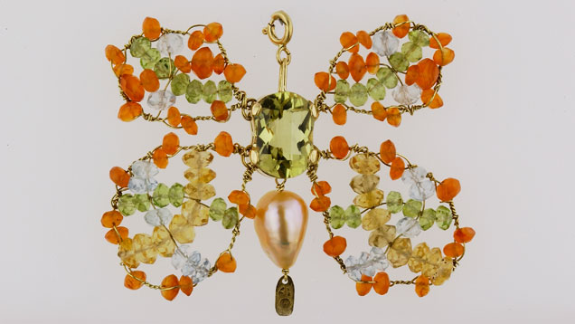 Designed by Bialice Duarte, this butterfly pendant in 18K yellow gold features a fantasy cut green gold quartz, peridot, aquamarine, citrine, tourmaline, and a freshwater rose pearl. Designed by Bialice Duarte, this butterfly pendant in 18K yellow gold features a fantasy cut green gold quartz, peridot, aquamarine, citrine, tourmaline, and a freshwater rose pearl.