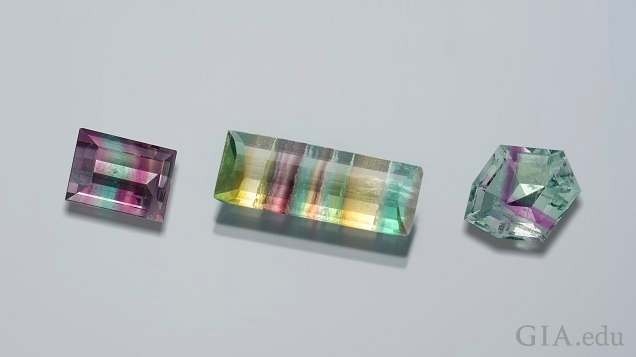 这些刻面氟石(正方形、长方形和八边形)呈现粉红色、紫色、绿色、黄色和蓝绿色色带。
