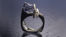 Though somewhat pale in color, this gray-violet iolite was skillfully carved and set into a distinctive ring. – Robert Weldon