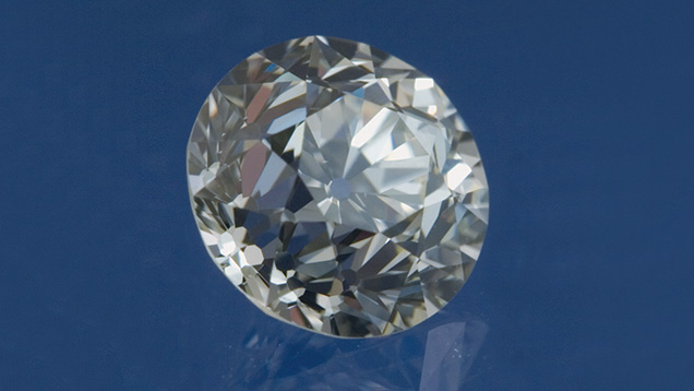 Compared to a modern round brilliant cut, this older-style 1.07-ct. brilliant has a much smaller table (38.5 percent), a higher crown, shorter lower halves, and a much larger culet. Digitally modified image by Al Gilbertson, © GIA, courtesy of Michael Goldstein 