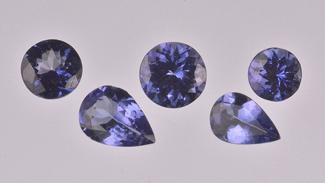 These five tanzanite samples (0.39–0.82 ct) proved to be colour-coated with titanium. Photo by Don Mengason.