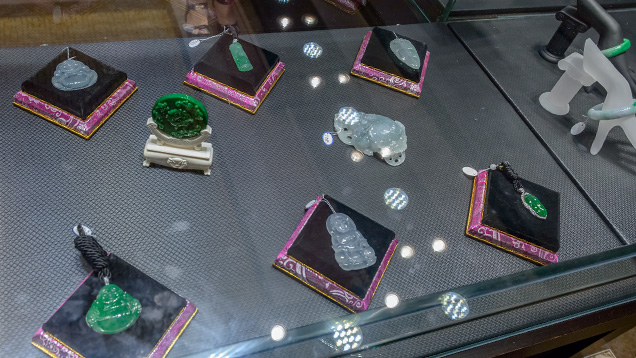 Jadeite pendants, decorations, and bangle in display case