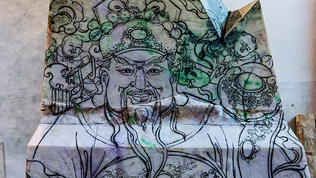 Close-up of sketch of Chinese god Lu on jadeite rough