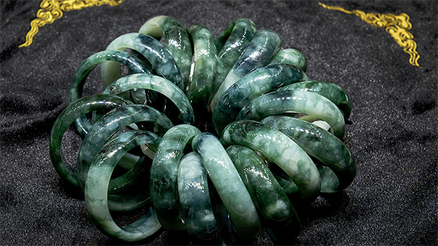 Cluster of colour-zoned jadeite bangles in a retail display
