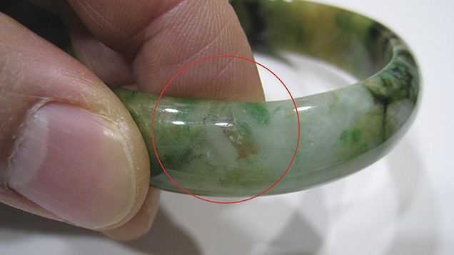 Jadeite bangle revealing natural inclusions