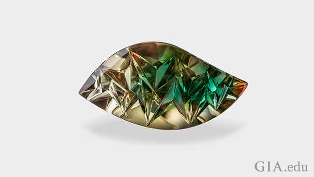 A carved wave-shaped gem with brown on the outer area and green in the center.