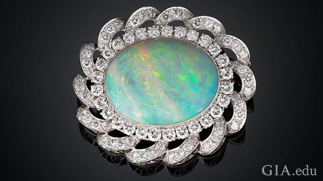 An oval shaped 33.40 ct white Australian opal and diamond pendant/brooch set in platinum.