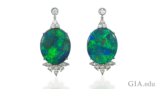 A pair of 18k white gold and black Australian opal and diamond earrings. The opal is 38.97cts.