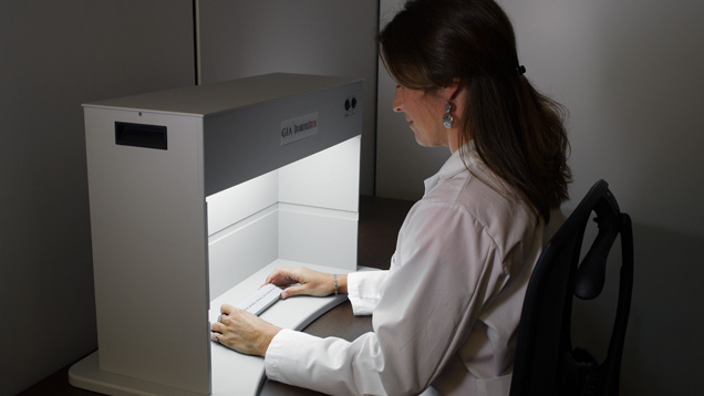 GIA Researcher observing diamonds in a Diamond Dock.