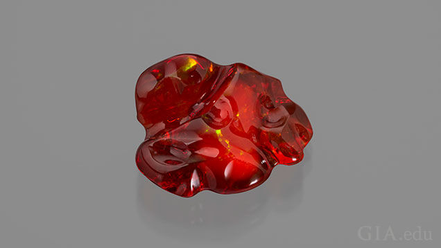 A free-form piece of orangey-red fire opal.