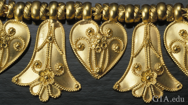 Detail of pendant elements heart and palmette shows twisted wire details (probably cast) and granulation soldered on.