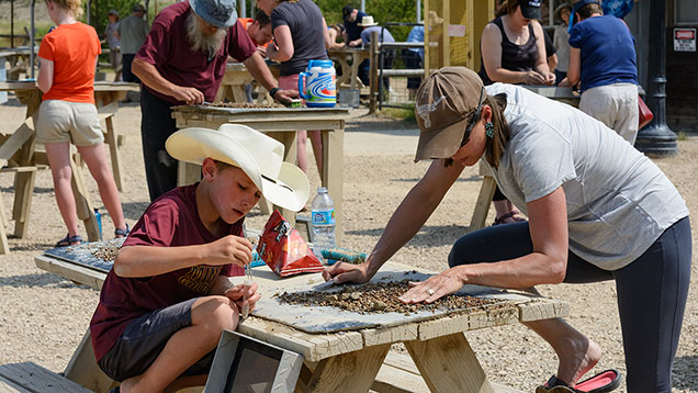 Boy and woman picking sapphires