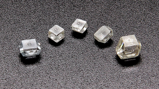 As-grown HPHT diamond single crystals produced using a simple Fe-based solvent with Al as a nitrogen getter. The sample on the far right is the largest, weighing 1.40 ct. Photo courtesy of New Diamond Technology.