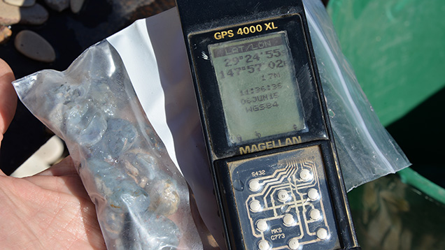 GPS unit and bag of black opal samples