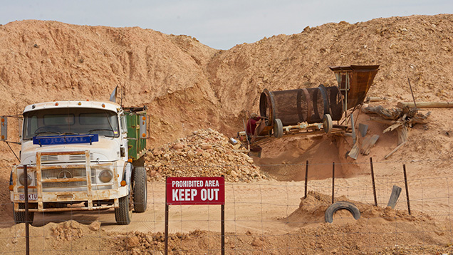 Trucks at boulder opal mining and processing site