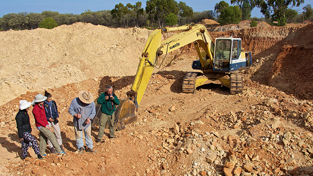 Group of people in an open-pit opal mine