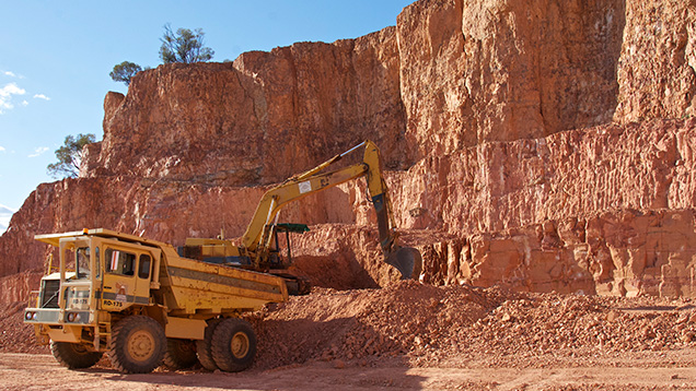 Truck and excavator working in opal mine