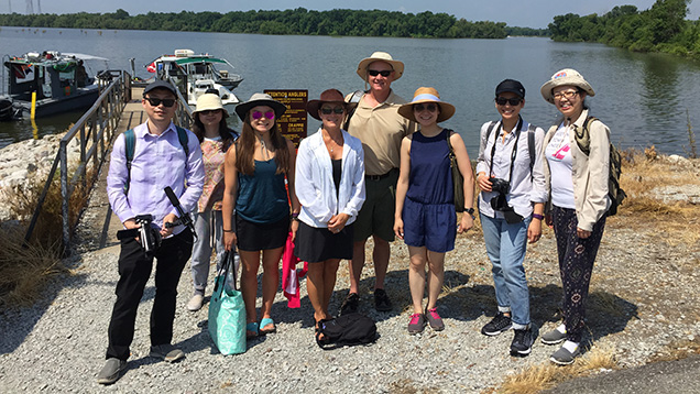 Group of eight people at lake’s edge