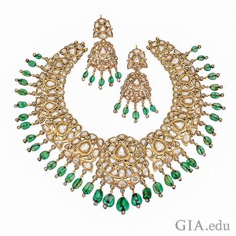 Image showing a necklace and two earrings with emeralds, diamonds and set in gold