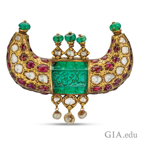 Horn shaped jewel pendant featuring emeralds, rubies, diamonds and pearls, and shows engravings in Arabic.