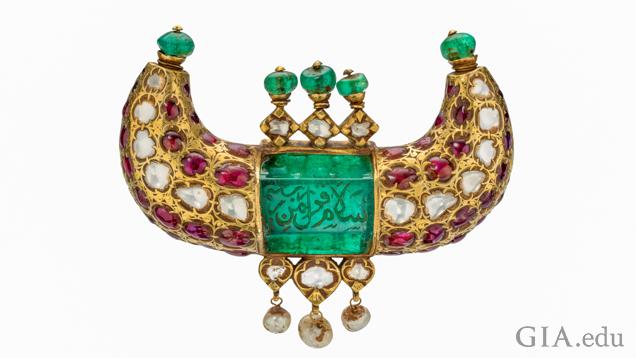 Horn shaped jewel pendant featuring emeralds, rubies, diamonds and pearls, and shows engravings in Arabic.