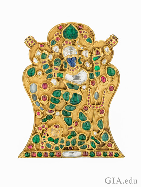 Gold Pendant of India god Shiva showing ruby, emerald, diamond, blue sapphire and cat’s eye chrysoberyl gems. 