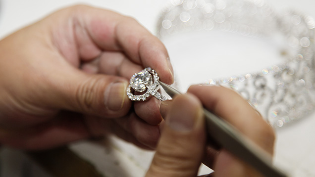 worker making final adjustments on a high-end diamond jewelry suite