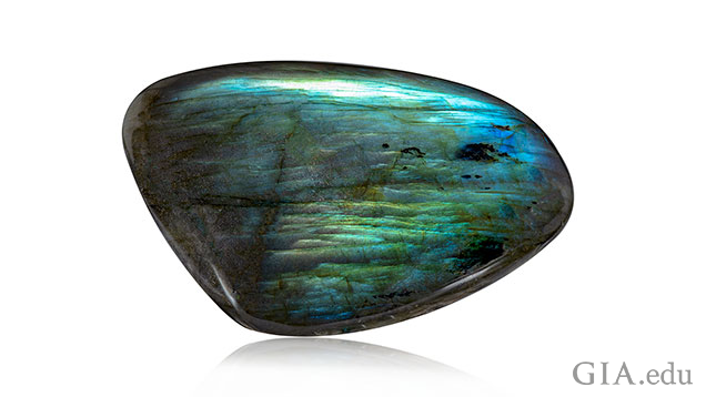 An elongated rectangle shape piece of labradorite.