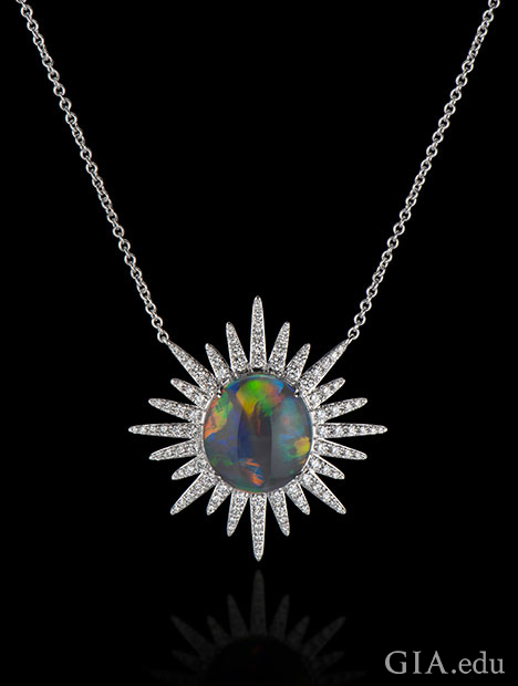 A 6.15 ct black opal in the center with 1.37 cts of diamonds radiating out in a starburst pattern. Set in 18kt white gold.