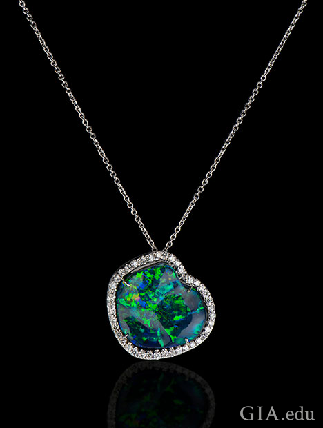 A 20.80 ct black opal set in 18kt white gold, accented with 1.26 cts of diamonds.