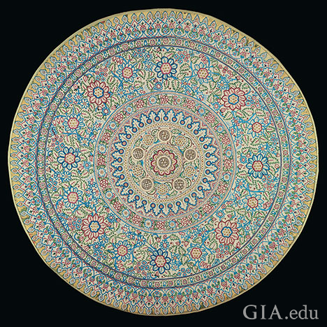 Thousands of natural pearls are set in geometric patterns on a round cloth, similar to a mandala.