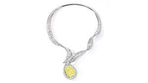 A diamond necklace that features a 100.02 Fancy Intense yellow diamond. The pendant is done in the shape of a musical instrument.