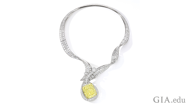 A diamond necklace that features a 100.02 ct Fancy Intense yellow diamond. The pendant is in the shape of a musical instrument.